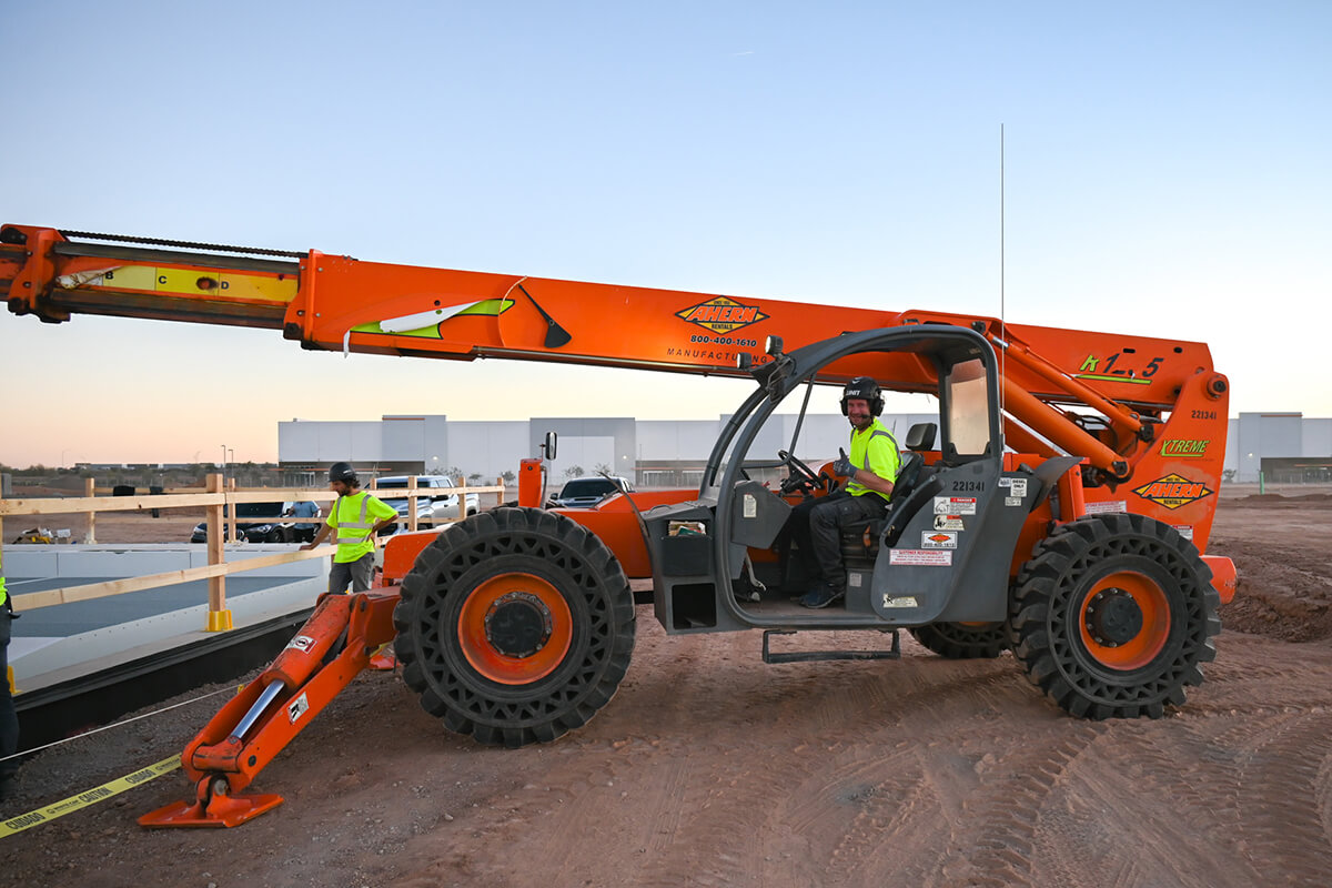 Johannes Degenhardt, founder of UNIT Surf Pool gives install a thumbs up on the all terrain forklift.