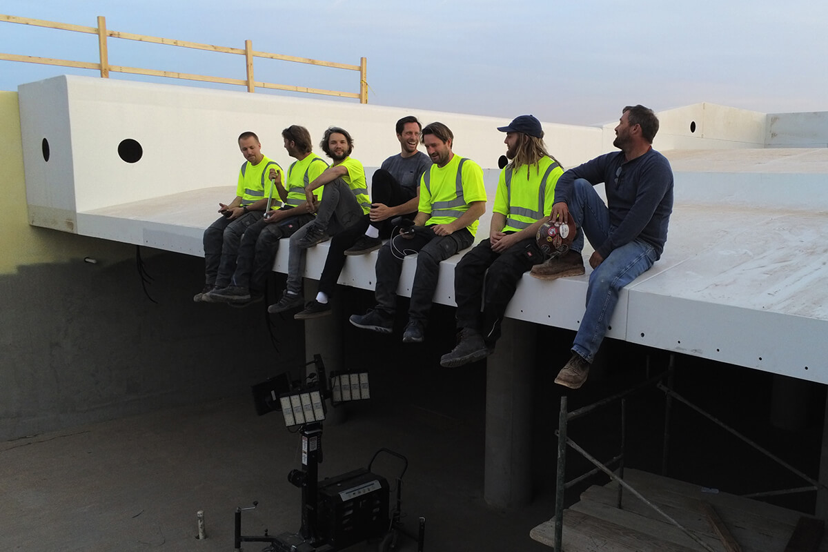 UNIT Surf Pool team sits on the edge of equipment.